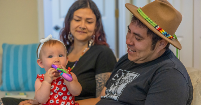 Infant girl sitting on fathers lap